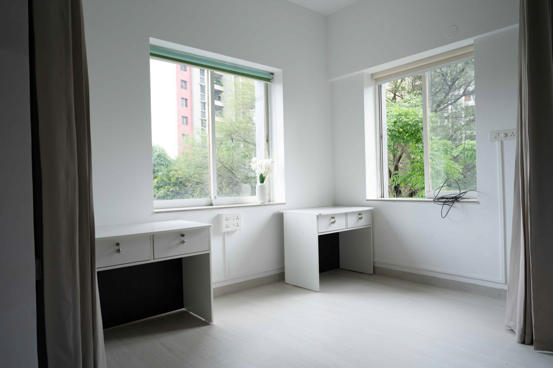 Front-facing sofa composition against sheer curtains